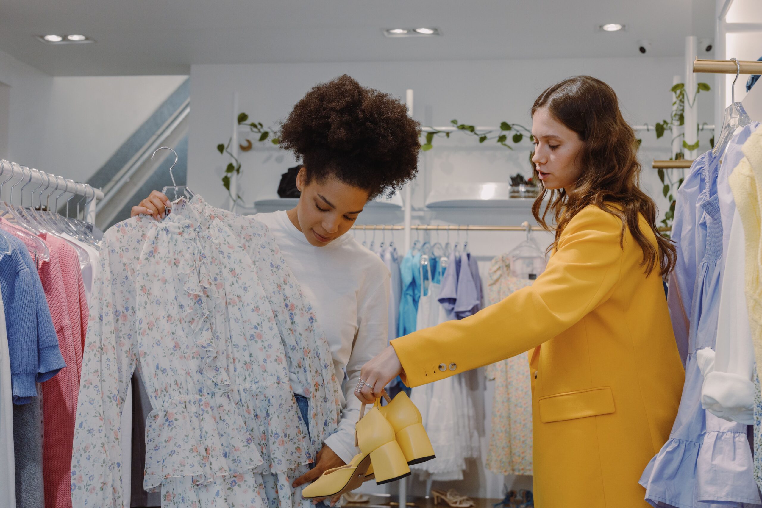 Two gorgeous women shopping for dresses and shoes